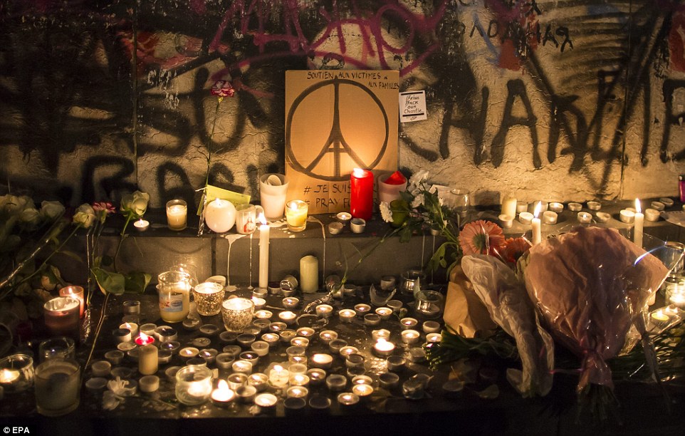 2E71A9FC00000578-3319244-Lit_up_People_place_flowers_and_light_candles_in_tribute_for_the-a-3_1447603508787
